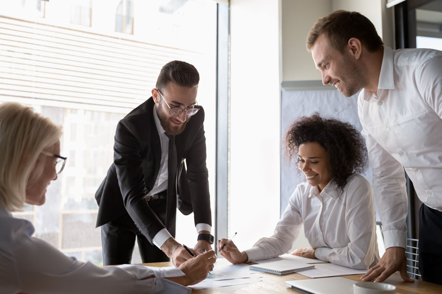 Middle eastern ethnicity chief financial officer and diverse corporate partners handles company finances gathered together at conference room reached positive results, teamwork and cooperation concept